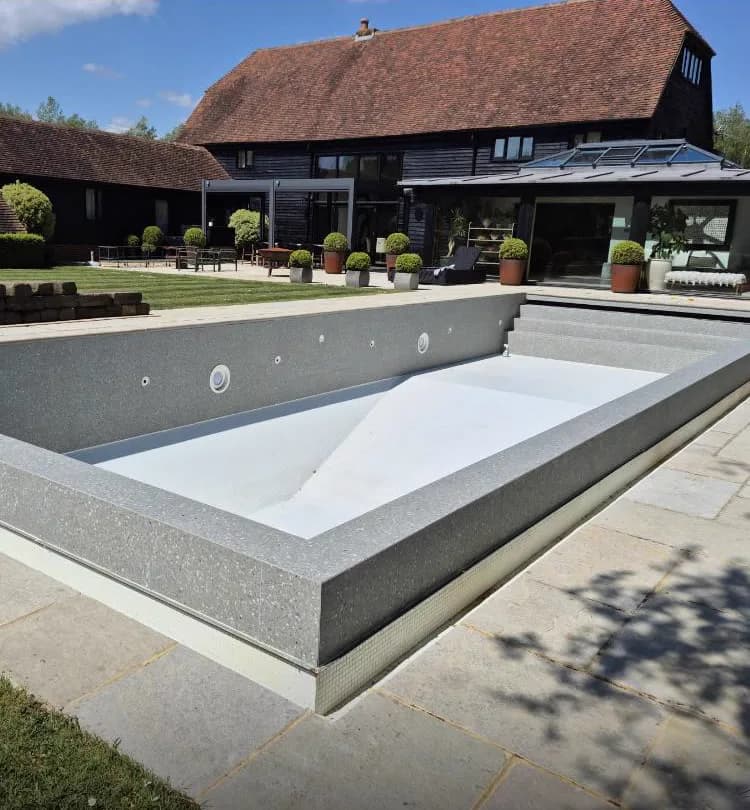 Turquoise glass mosaic swimming pool with terrazzo coping, Banks and Co Ceramics pool tiling